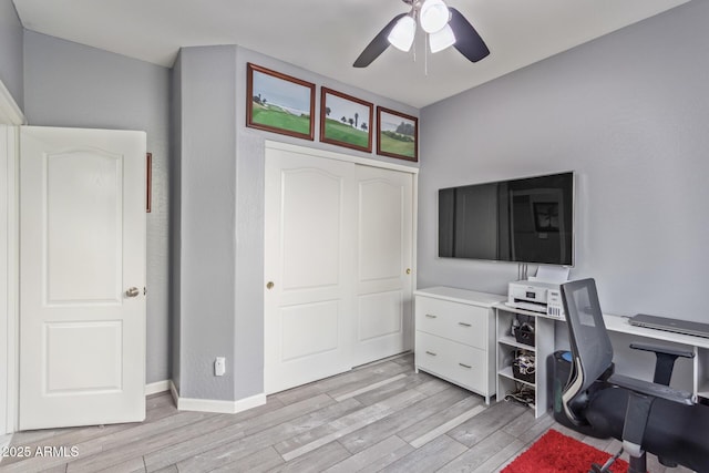office with light wood-type flooring and a ceiling fan