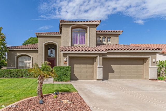 mediterranean / spanish house featuring a front lawn, driveway, stucco siding, and a tiled roof