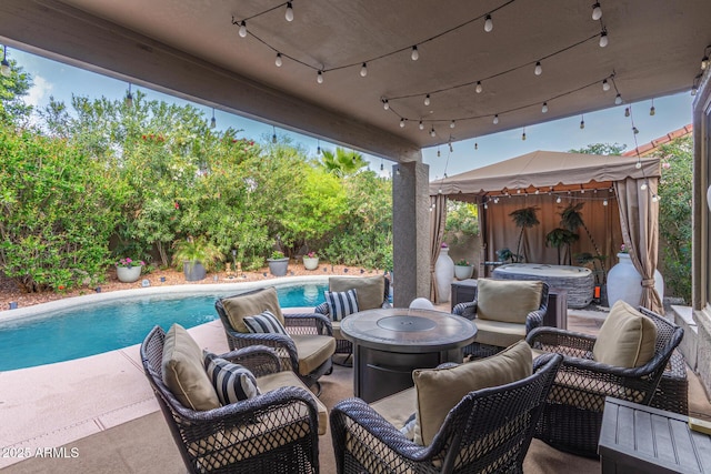 view of patio / terrace featuring a gazebo, outdoor lounge area, and a fenced in pool