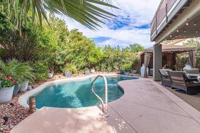 pool featuring a patio and a gazebo