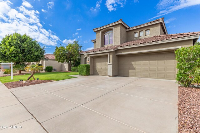 mediterranean / spanish-style house with stucco siding, concrete driveway, an attached garage, and a tile roof