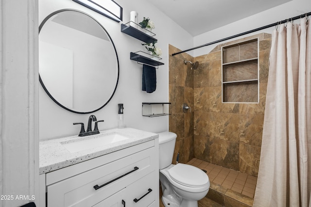 bathroom with walk in shower, vanity, and toilet