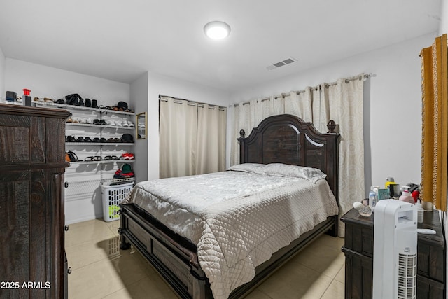 bedroom with light tile patterned floors