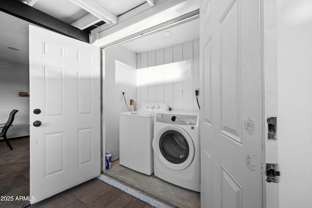 clothes washing area featuring separate washer and dryer