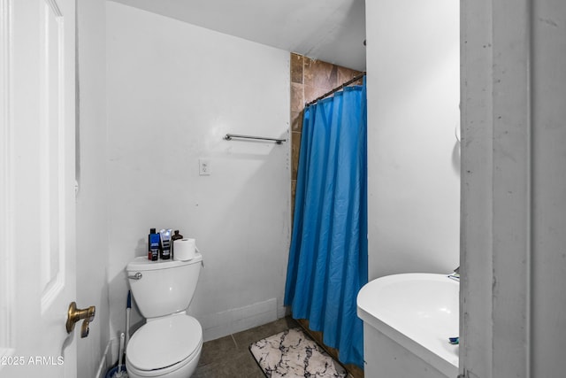 bathroom with tile patterned floors, toilet, and a shower with shower curtain