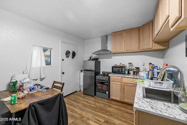 kitchen with wall chimney range hood, sink, appliances with stainless steel finishes, dark hardwood / wood-style floors, and light brown cabinetry