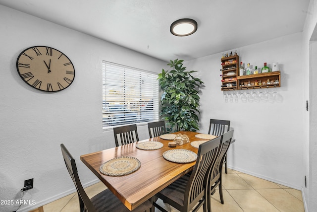 dining space featuring light tile patterned floors