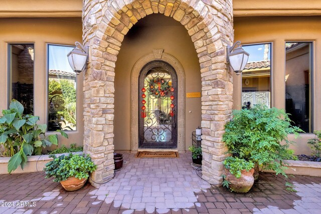 entrance to property with stone siding and stucco siding