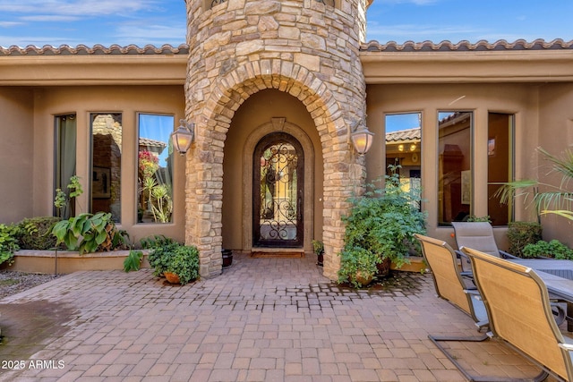 4301 E Taurus Pl, Chandler, AZ 85249 - entrance to property featuring stucco siding, a patio area, and stone siding