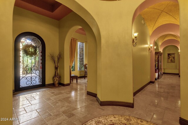 foyer entrance with stone tile flooring and baseboards