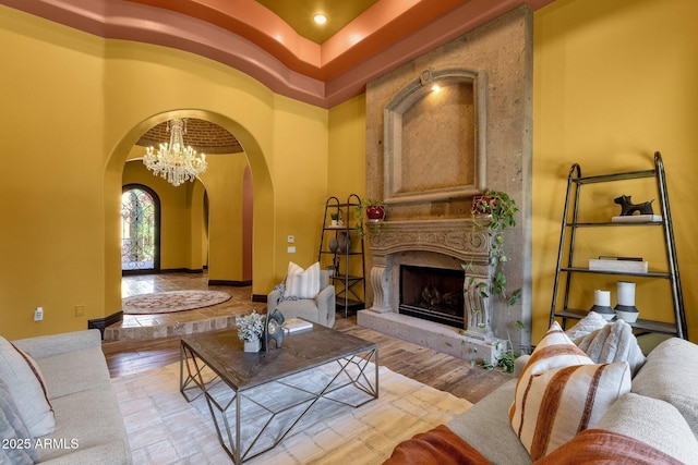 4301 E Taurus Pl, Chandler, AZ 85249 - living room with arched walkways, a high end fireplace, and a chandelier