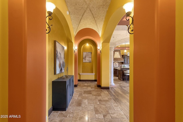 4301 E Taurus Pl, Chandler, AZ 85249 - corridor with stone tile floors, arched walkways, and vaulted ceiling