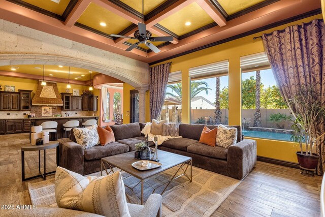 4301 E Taurus Pl, Chandler, AZ 85249 - living room featuring arched walkways, a ceiling fan, coffered ceiling, crown molding, and beamed ceiling