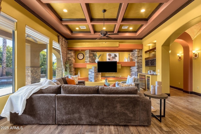 4301 E Taurus Pl, Chandler, AZ 85249 - living area with arched walkways, healthy amount of natural light, coffered ceiling, wood finished floors, and beamed ceiling