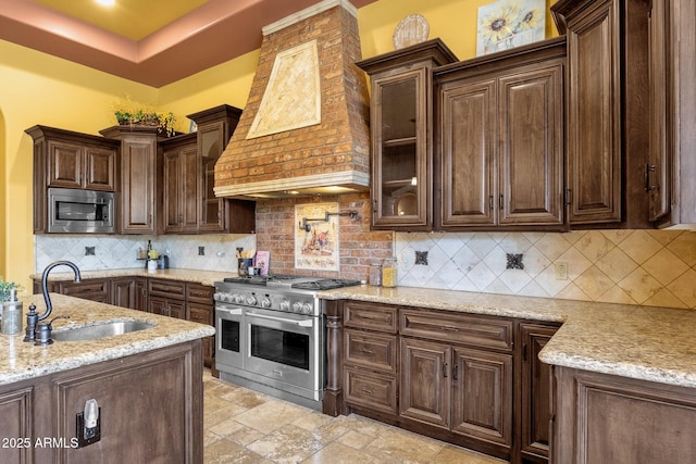 4301 E Taurus Pl, Chandler, AZ 85249 - kitchen featuring appliances with stainless steel finishes, custom exhaust hood, dark brown cabinetry, and light stone countertops