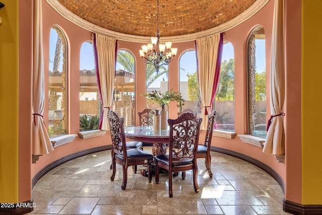 4301 E Taurus Pl, Chandler, AZ 85249 - dining space featuring stone tile floors, a chandelier, healthy amount of natural light, ornamental molding, and a towering ceiling