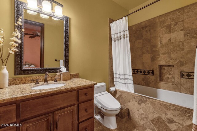 full bath featuring a ceiling fan, tiled shower / bath, toilet, and vanity