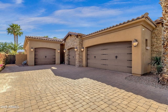 4301 E Taurus Pl, Chandler, AZ 85249 - mediterranean / spanish house featuring stucco siding, driveway, a garage, a tile roof, and stone siding