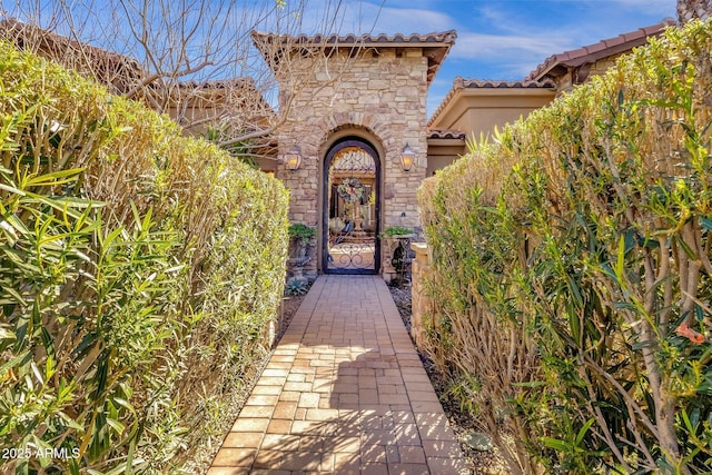 4301 E Taurus Pl, Chandler, AZ 85249 - entrance to property with a tiled roof, stone siding, and stucco siding