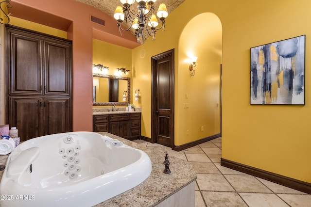 4301 E Taurus Pl, Chandler, AZ 85249 - bathroom featuring tile patterned floors, a tub with jets, a chandelier, vanity, and vaulted ceiling