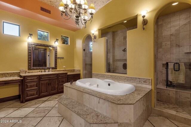 full bath with a chandelier, a stall shower, vanity, and a bath