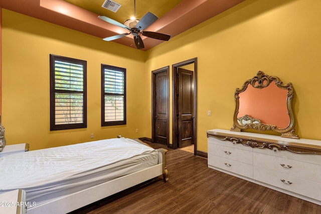 4301 E Taurus Pl, Chandler, AZ 85249 - bedroom featuring dark wood-style flooring and a raised ceiling