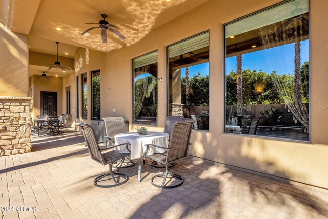 view of patio / terrace featuring fence, a ceiling fan, and outdoor dining space