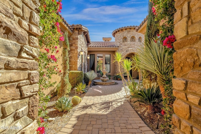 4301 E Taurus Pl, Chandler, AZ 85249 - entrance to property featuring a tile roof, stone siding, and stucco siding