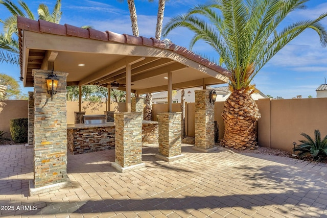 4301 E Taurus Pl, Chandler, AZ 85249 - fenced backyard with exterior kitchen, ceiling fan, and a patio area