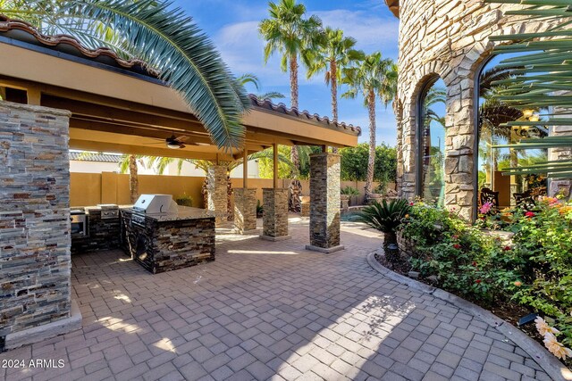 view of patio with a fenced backyard, a grill, and exterior kitchen