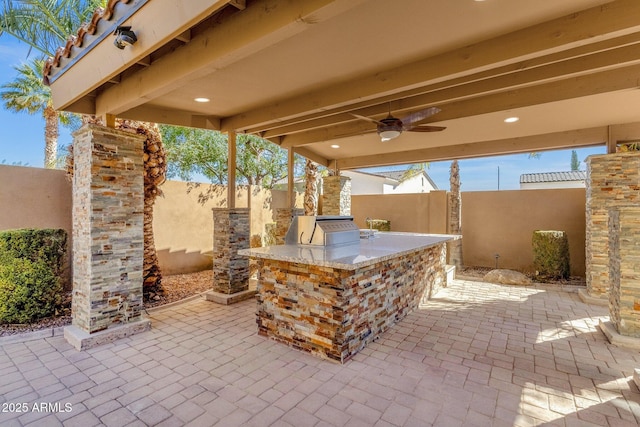 4301 E Taurus Pl, Chandler, AZ 85249 - fenced backyard featuring exterior kitchen, a patio area, and ceiling fan