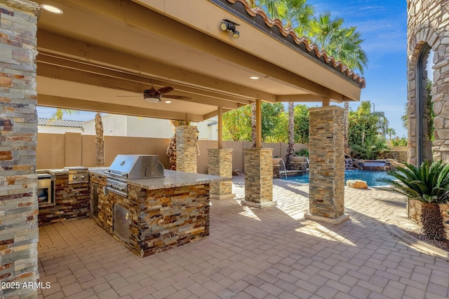 4301 E Taurus Pl, Chandler, AZ 85249 - fenced backyard with an outdoor kitchen, a ceiling fan, a patio area, and a pool with connected hot tub