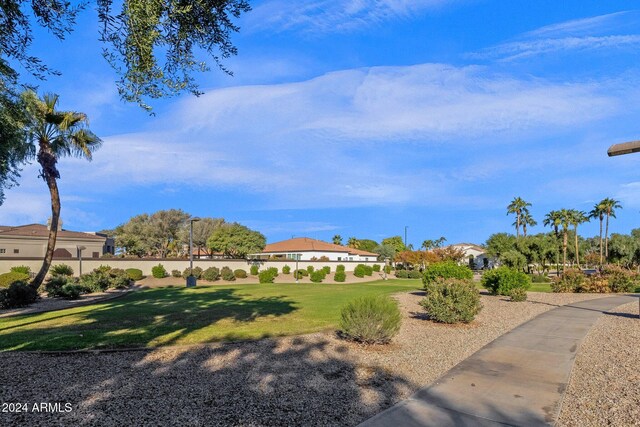 surrounding community featuring a yard and fence