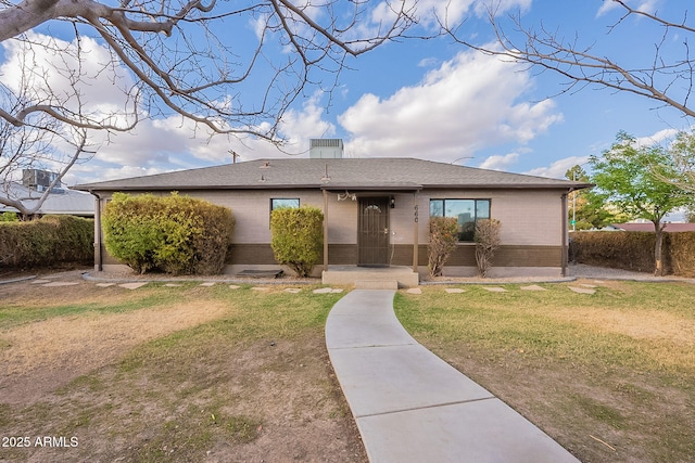 ranch-style house with brick siding and a front lawn