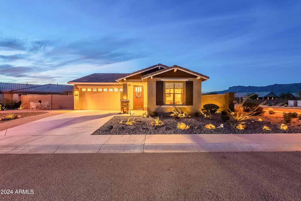 view of front of home with a mountain view and a garage