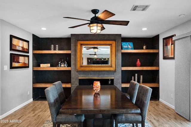 8730 E Montecito Ave, Scottsdale, AZ 85251 - dining area featuring baseboards, wood finished floors, ceiling fan, built in features, and recessed lighting