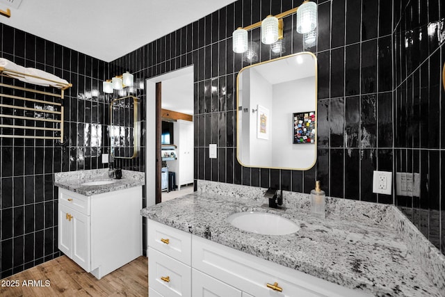 8730 E Montecito Ave, Scottsdale, AZ 85251 - full bathroom with tile walls, two vanities, and wood finished floors