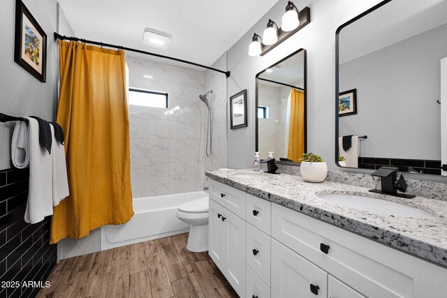 8730 E Montecito Ave, Scottsdale, AZ 85251 - full bathroom with double vanity, shower / bath combination with curtain, toilet, and wood finished floors