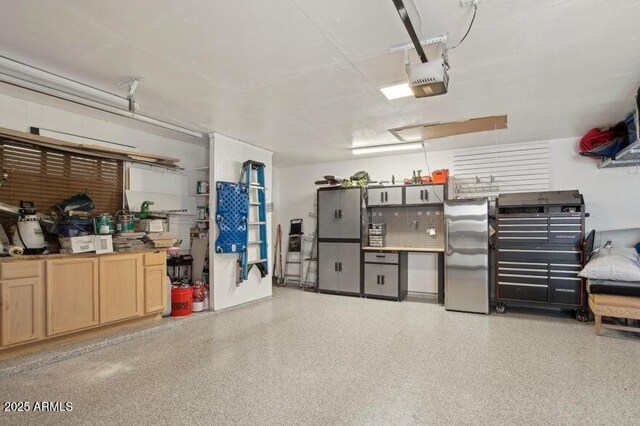 8730 E Montecito Ave, Scottsdale, AZ 85251 - garage with freestanding refrigerator and a garage door opener