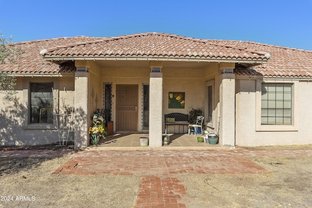 doorway to property with a patio area