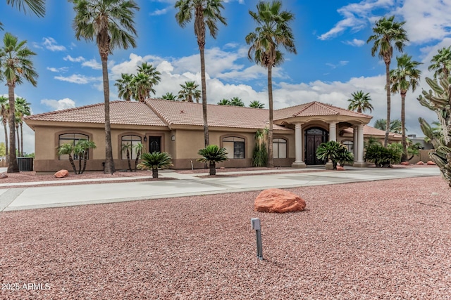 23644 N 67th Ave, Peoria, AZ 85383 - mediterranean / spanish house with curved driveway, stucco siding, cooling unit, and a tiled roof