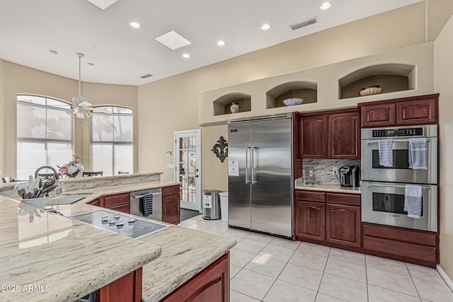 23644 N 67th Ave, Peoria, AZ 85383 - kitchen with a sink, stainless steel appliances, light tile patterned floors, tasteful backsplash, and visible vents