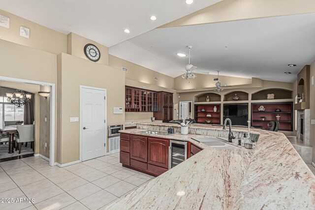 23644 N 67th Ave, Peoria, AZ 85383 - kitchen with lofted ceiling, light tile patterned flooring, beverage cooler, a sink, and ceiling fan with notable chandelier