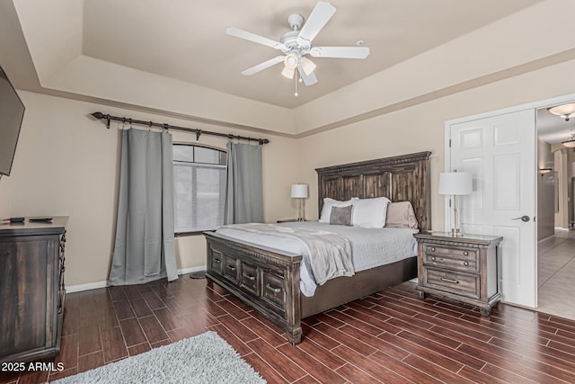 23644 N 67th Ave, Peoria, AZ 85383 - bedroom featuring baseboards, wood tiled floor, and a tray ceiling