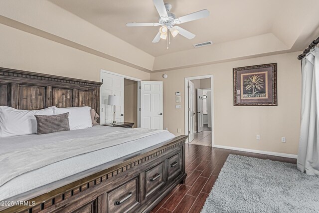 23644 N 67th Ave, Peoria, AZ 85383 - bedroom with visible vents, baseboards, a tray ceiling, and dark wood finished floors