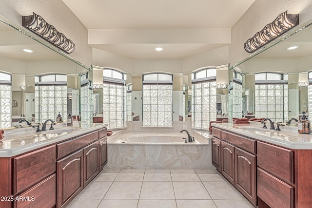 23644 N 67th Ave, Peoria, AZ 85383 - bathroom featuring a garden tub, a sink, tile patterned floors, and two vanities