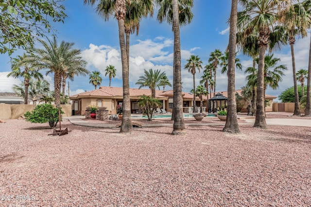 23644 N 67th Ave, Peoria, AZ 85383 - view of front facade with a community pool, a gazebo, fence, and stucco siding