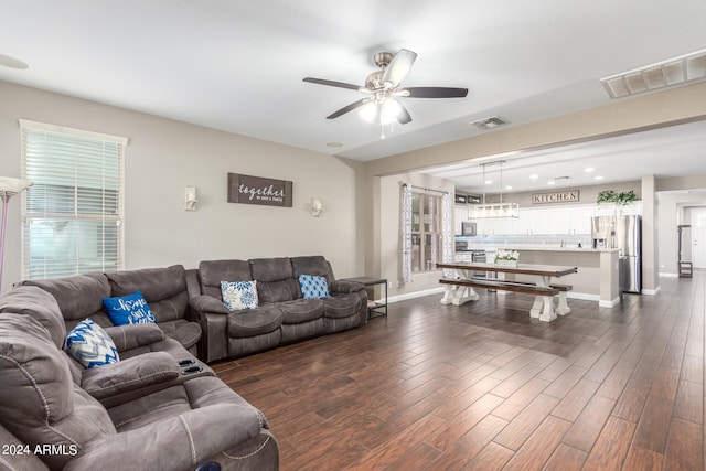 living room with ceiling fan, plenty of natural light, and dark hardwood / wood-style flooring