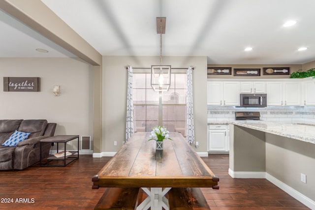 dining space with dark hardwood / wood-style floors