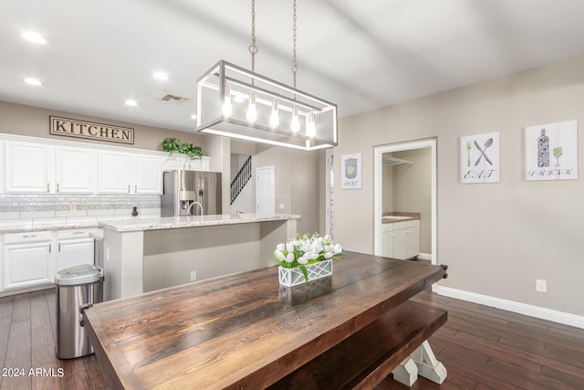 dining space featuring dark wood-type flooring